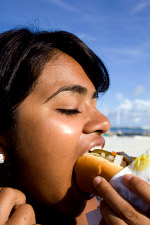 Girl eating hot dog